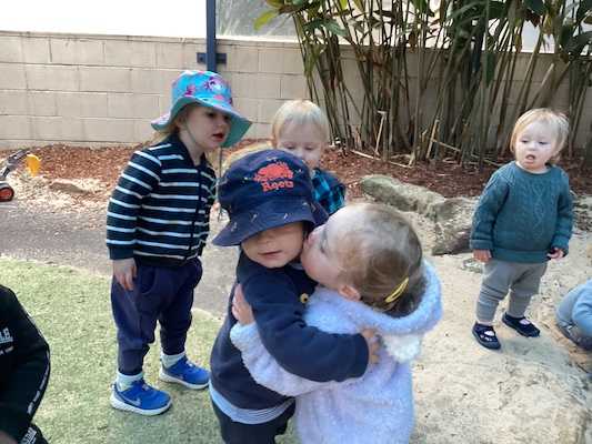 Avery hugging a friend at day care