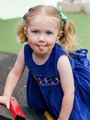 Avery posing for her annual day care photos