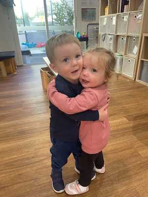 Avery hugging a friend at day care